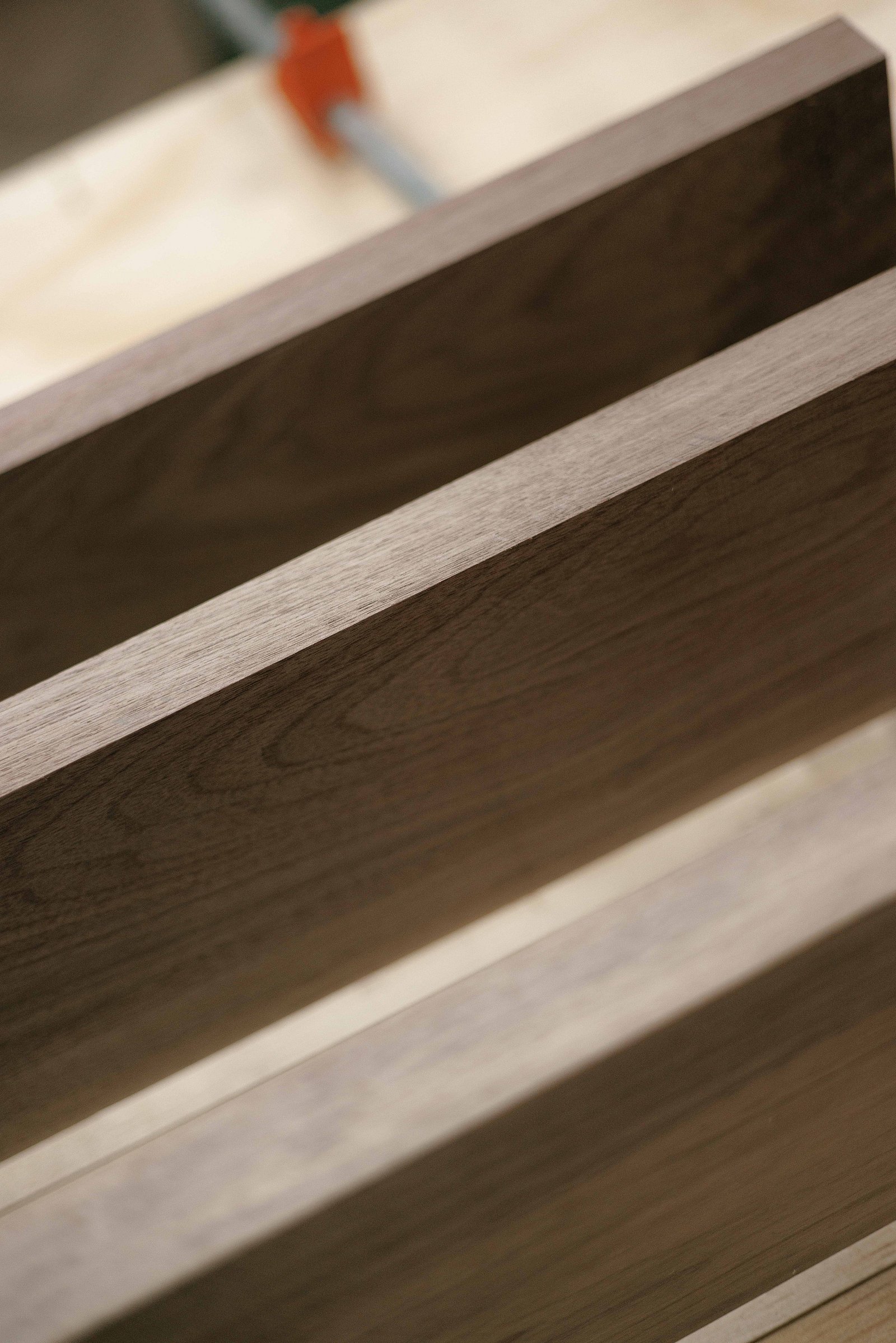 A stack of high-quality, premium wood planks showing beautiful grain.