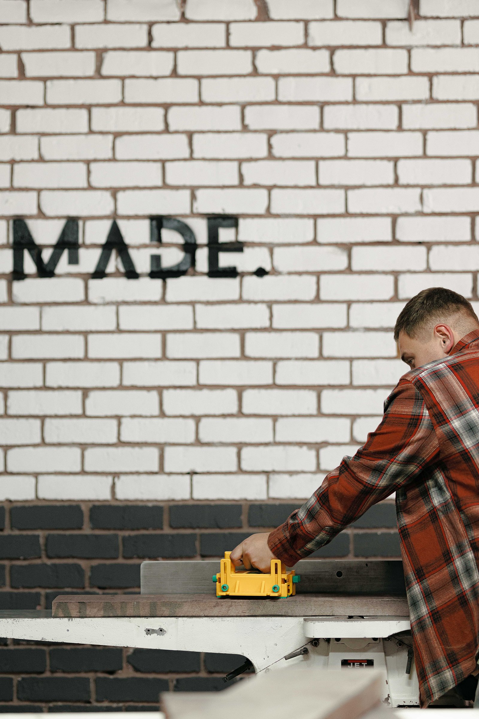 The Made. workshop, clean and organized, showcasing tools and wood for custom furniture.