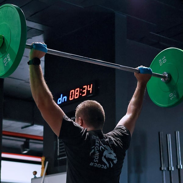 Coach guiding an athlete on proper form at CrossFit Ari